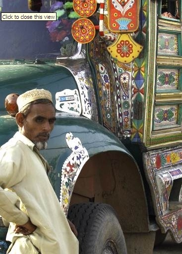 A Pakistani relief worker waits while his truck is unloaded