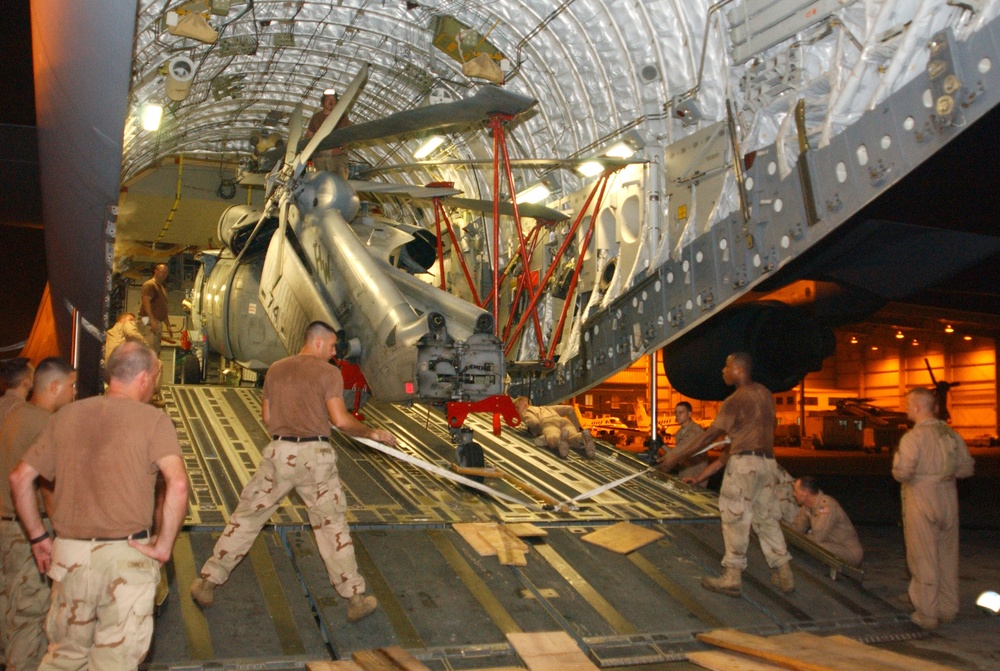Devon Kimble and Roderick Woods Help Load a Helicopter Onto a C-17