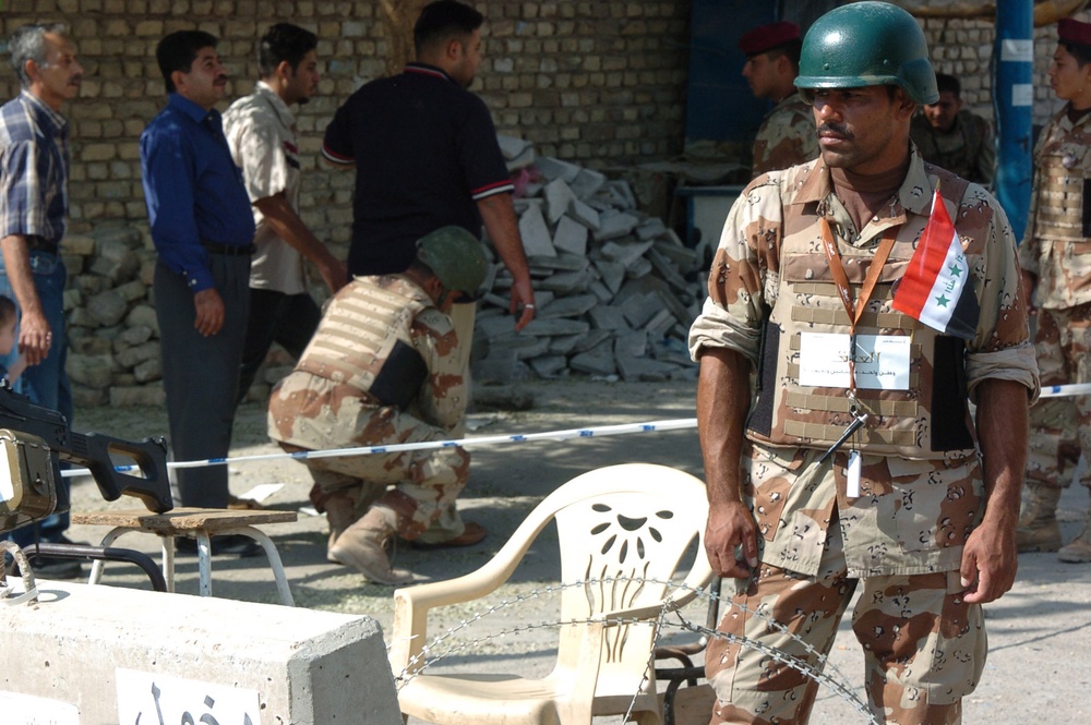 An Iraqi Soldier keeps a watchful eye out for suspicious activity