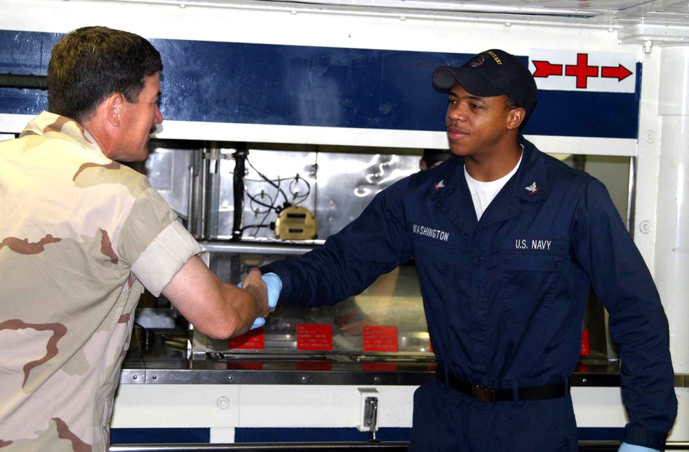 MCPON Scott greets  Quartermaster 3rd Class Washington