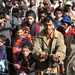 A Crowd of People Gather to Watch as Supplies Are Loaded Off of an MH-53 Se