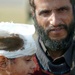 A Pakistani Father Carries His Son to an MH-53 Sea Stallion