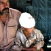 A Pakistani Father Sits With His Son on an MH-53 Sea Stallion Helicopter