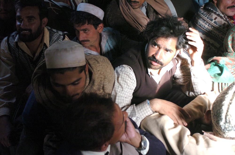 Injured Pakistani Citizens Sit on the Floor of an MH-53 Sea Stallion