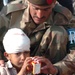An Injured Pakistani Boy Is Given a Box of Juice