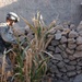 Pfc. Cuellar uses a metal detector to search a wall