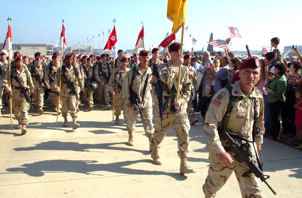 Paratroopers past hundreds of cheering friends and families
