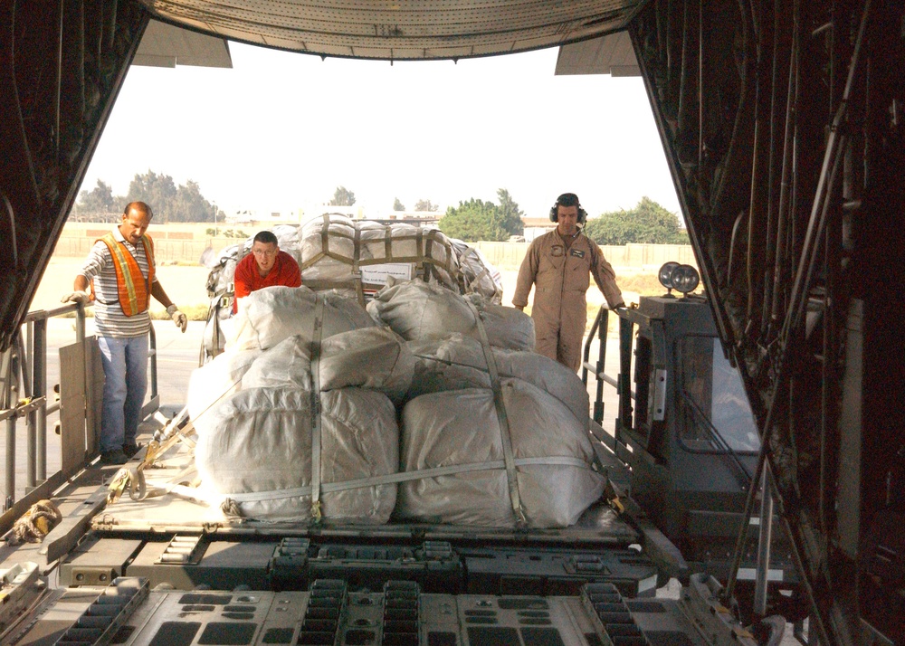 A Sailor helps to load pallets bound for Pakistan