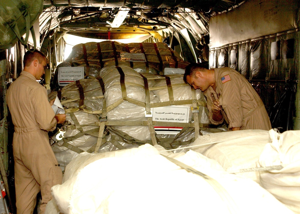 Sailors load pallets bound for Pakistan