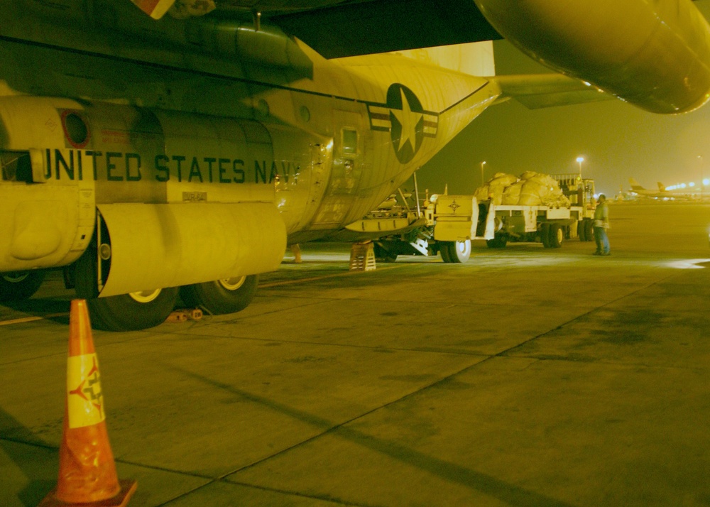 Food and equipment are unloaded from a C-130