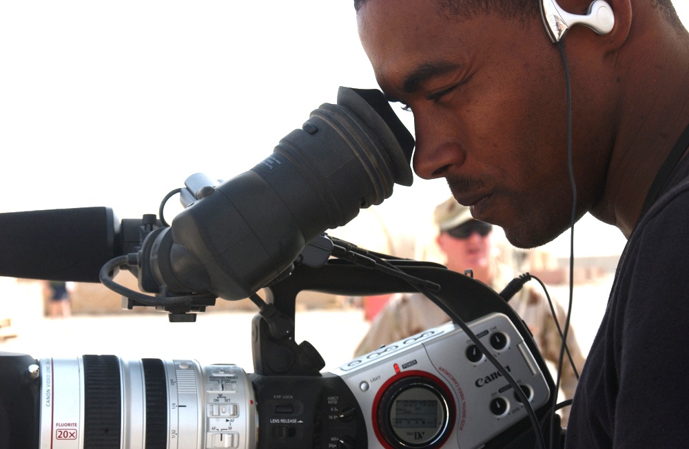 Airman Magee checks if his subject is framed properly