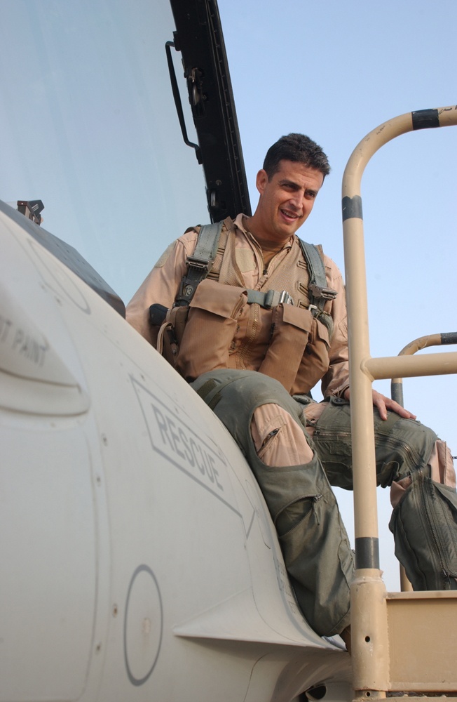 Lt. Col. Jose Monteagudo gets into the cockpit of his F-16