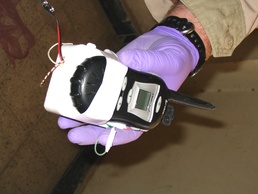 A Task Force Baghdad Soldier holds up a triggering mechanism