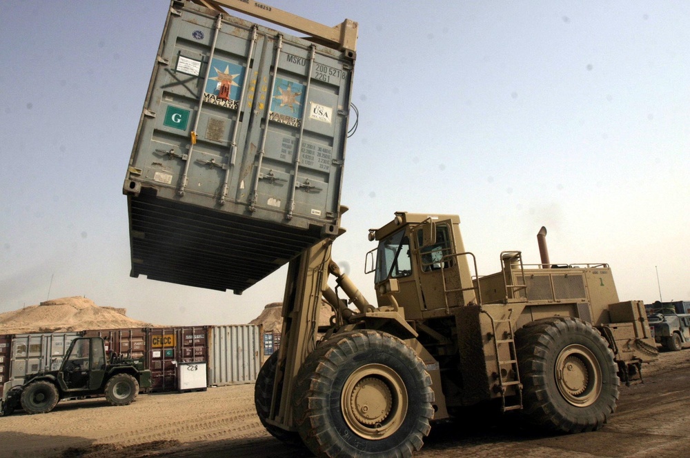 A Rough Terrain Cargo Handler moves an ISO container