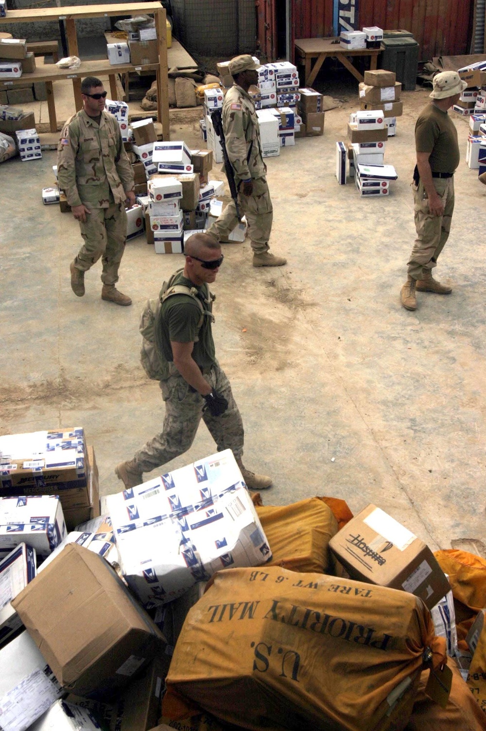 Sgt. Baker Walks by a Shipment of Mail