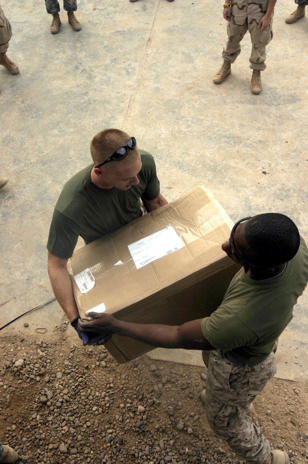 Cpl. Huebner and Pfc. Hill Unload a Care Package