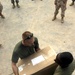 Cpl. Huebner and Pfc. Hill Unload a Care Package