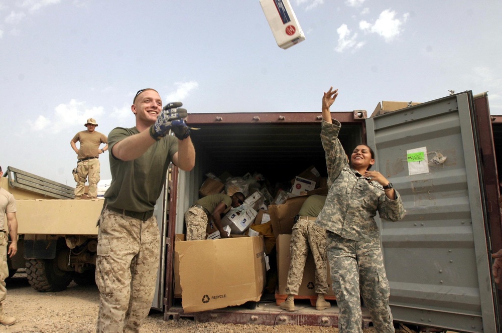 Cpl. Huebner and Spc. Cardenas Unload a Shipment of Mail