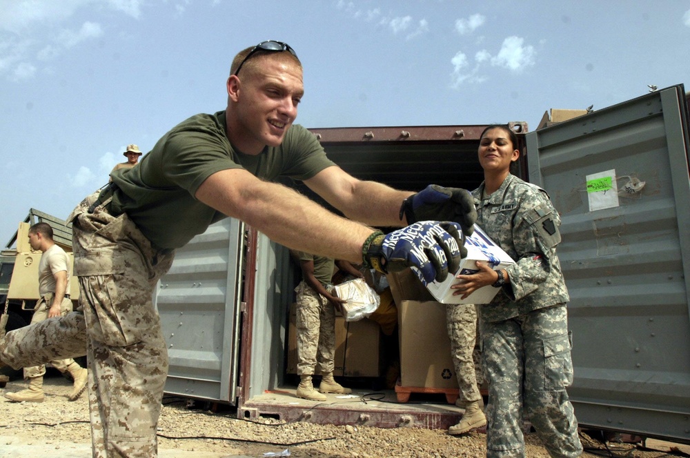 Cpl. Huebner and Spc. Cardenas Unload a Shipment of Mail