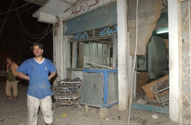 U.S. Soldiers survey Palestine Hotel damage