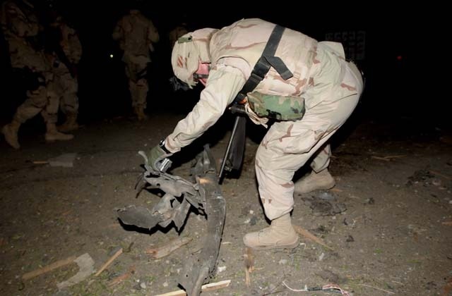 U.S. Soldiers survey Palestine Hotel damage