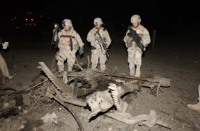 U.S. Soldiers survey Palestine Hotel damage