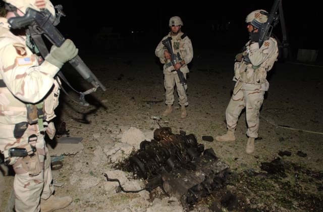 U.S. Soldiers survey Palestine Hotel damage