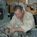 Spc. Scot S. Sheftz Plugs a Generator Into a Humvee