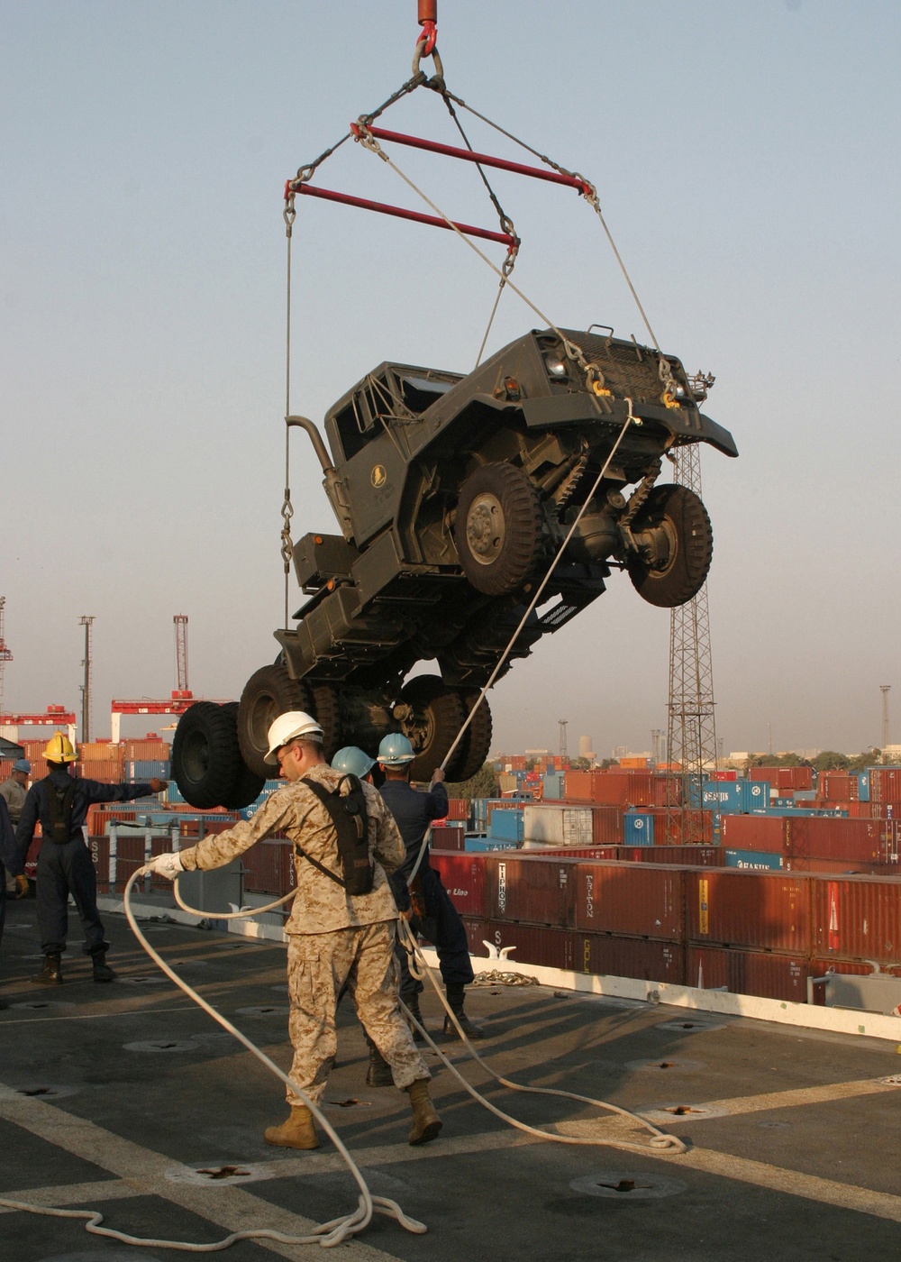 Gunnery Sgt. Brown Assists Sailors With the Offloading of a Seven-ton Truck