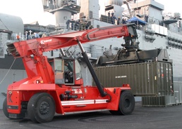A Pakistani Heavy Equipment Operator Moves a Container of Constr