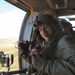 A Helicopter Crew Member Tosses Toys to the Children in the Village Below.