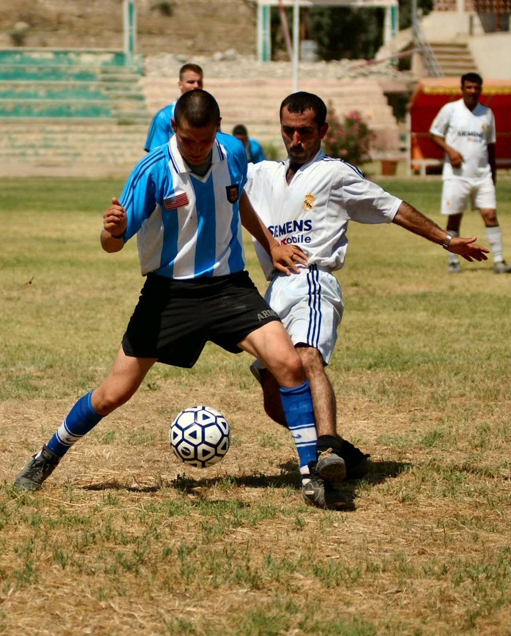 Iraqi and US Soldiers play soccer