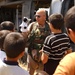 CW3 John Paul King gives a small puppet show for Iraqi children