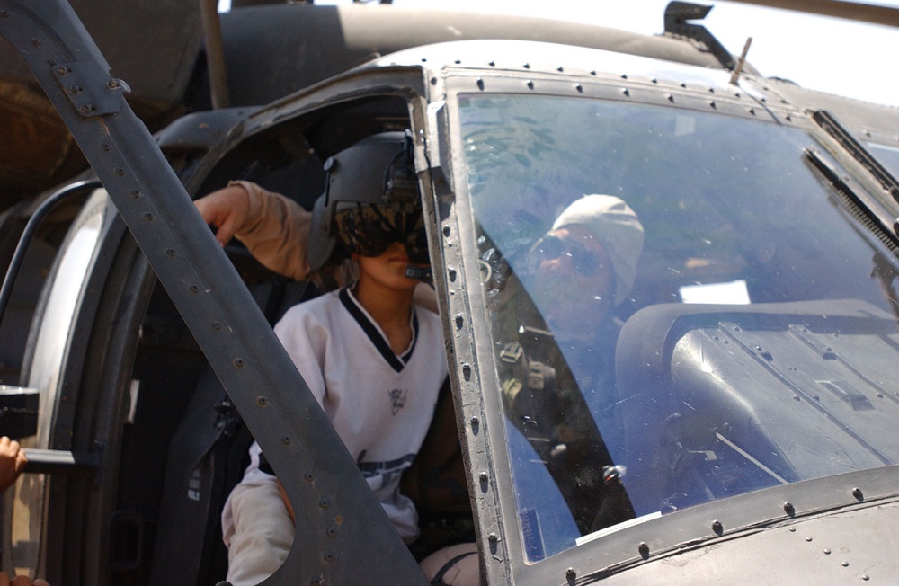 An Iraqi child gets a look at the black hawk helicopter with CW3