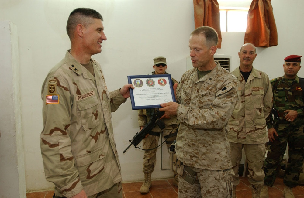 Maj. Gen. David Rodriguez Presents an Award to a Marine