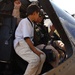 CW3 John Paul King shows an Iraqi child the inside of a Blackhawk