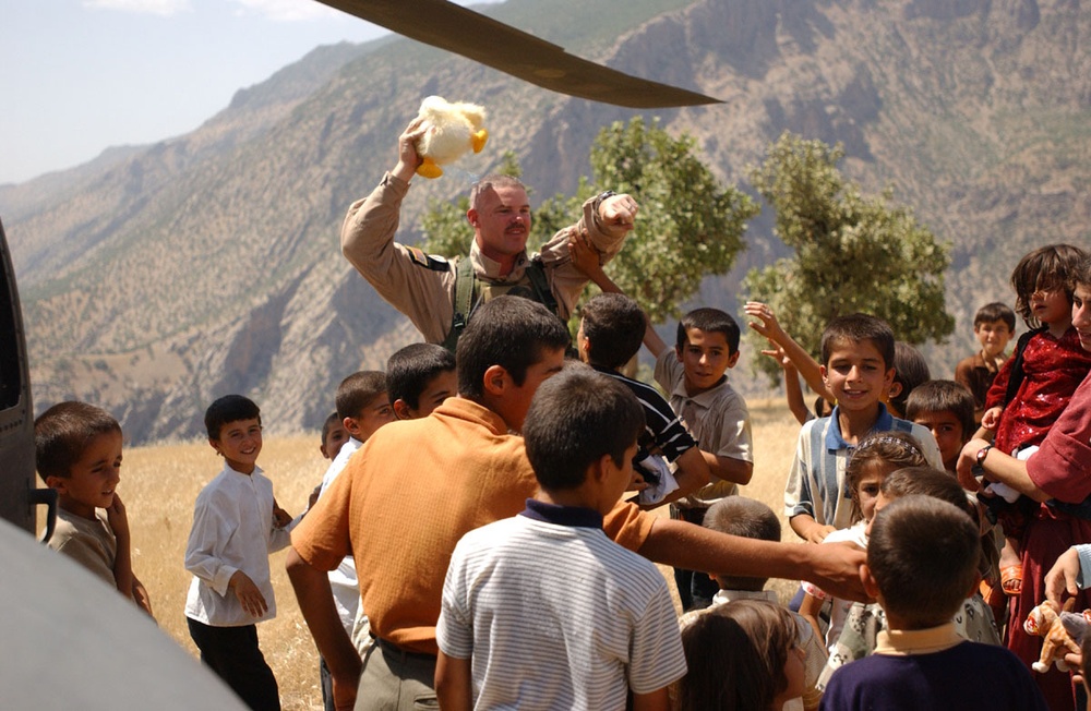 SSG Bill Gard hands out toys to Iraqi children