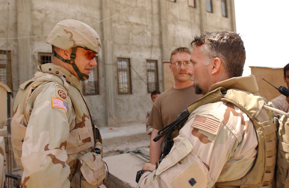 Maj. Gen. David Rodriguez talks to local Soldiers who are training