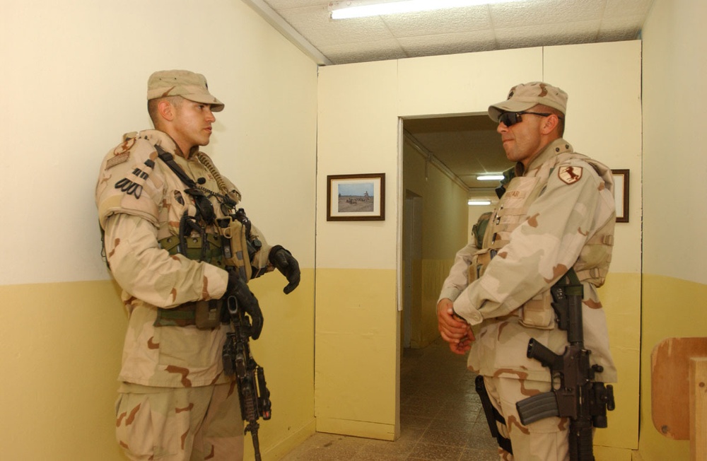 Spc. Ben Heck and SFC Edward Huizar pull security outside a meeting