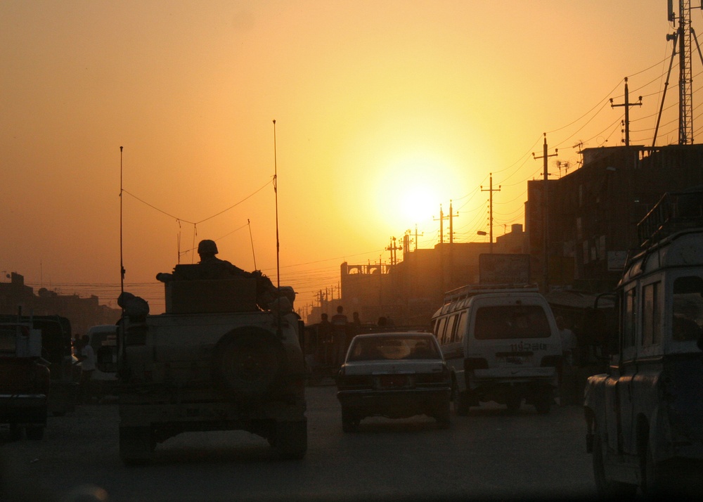 A Rhode Island National Guard unit is silhouetted by the setting sun