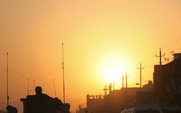 A Rhode Island National Guard unit is silhouetted by the setting sun