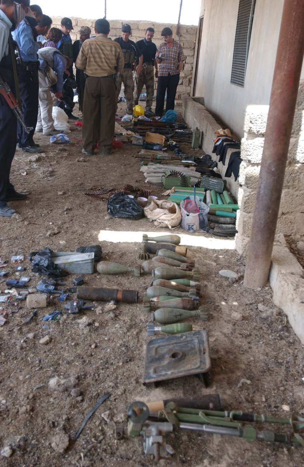 Iraqi Police inventory a weapons cache