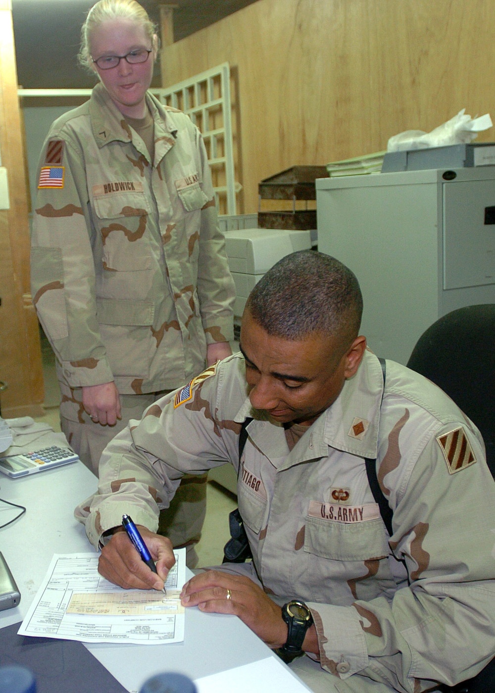 Maj. Santiago signs a dinar check