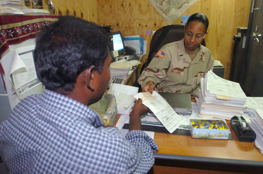 1st Lt. Williams issues a dinar check to a local contractor