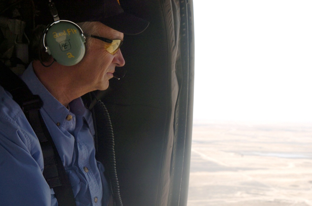 Idaho governor Kempthorne gazes out the door of a Black Hawk