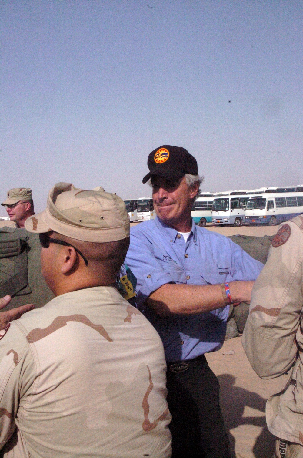 Idaho Governor Kempthorne Helps Soldiers Load Duffel Bags Onto a Truck