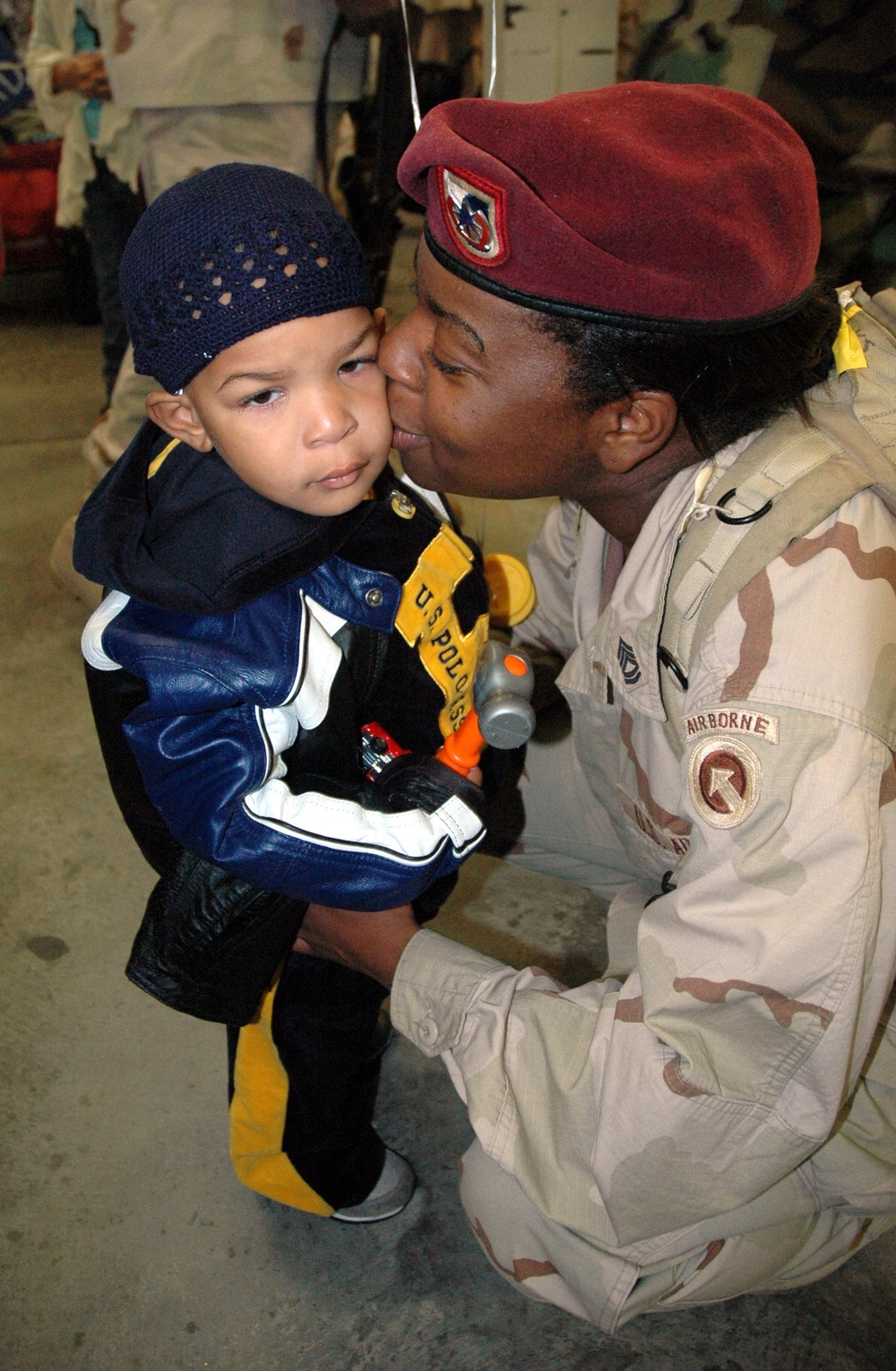 Sgt. 1st Class Vache Brooks kisses her 3-year-old son, Robert