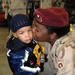 Sgt. 1st Class Vache Brooks kisses her 3-year-old son, Robert