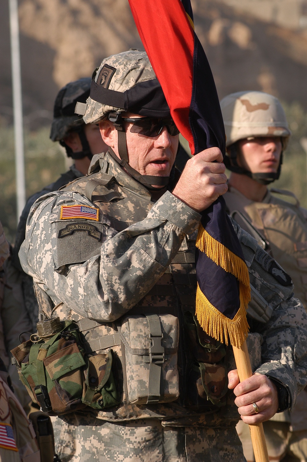 Command Sgt. Maj. Frank A. Grippe accepts the Division's Colors