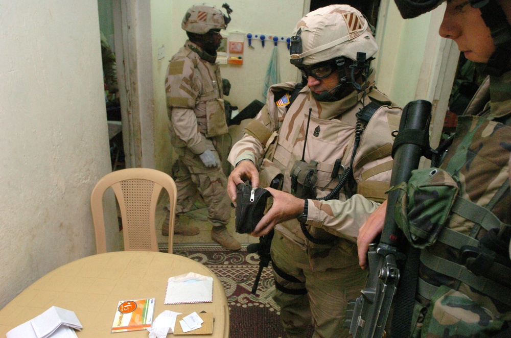 CSM Smith examines evidence gathered during a raid in Zafarania